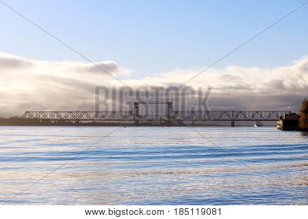 white cumulus clouds pass bridge over the Northern Dvina River.
