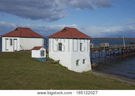 PUERTO NATALES, CHILE - APRIL 10, 2017: Historic buildings and pier of a former meat refrigeration plant that have been renovated and converted into a luxury hotel.