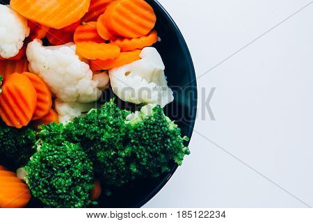Fresh vegetables broccoli, carrots, cauliflower steamed. Healthy lifestyle, vitamins. On a white background. Vegetarian