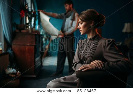 Artist looking at canvas painting against poseur