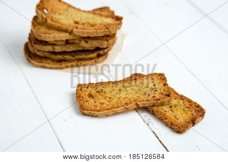 Crostini without toppings on a white background. A crostino is a small slice of toasted or grilled bread used in Italian cuisine for appetizers. It's an healthy food a versatile snack to eat just plain with vegetables cheeses or meats!