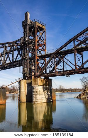 Historical bridge over Arkansas River with reflections