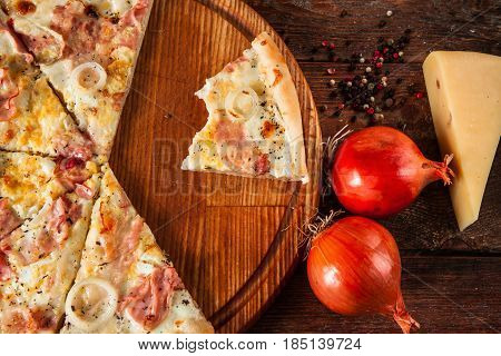 Junk food, bad habits. Pizza sliced on rustic wooden table background. Italian traditional meal