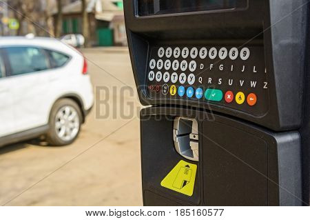 Close up of parking meter with colorful buttons in the street
