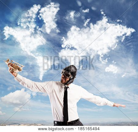 Man playing with a wooden airplane dreaming trips around the full world
