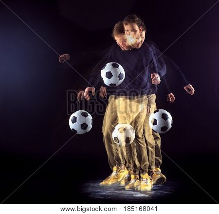 A portrait of a fan with ball on gray studio background. Freestile concept. Stroboscope shooting technique