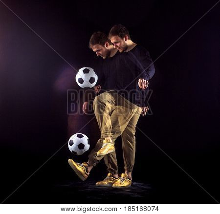 A portrait of a fan with ball on gray studio background. Freestile concept. Stroboscope shooting technique