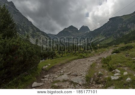 Mountain overgrown with coniferous forest, glade and rest-house toward Maliovitza peak in Rila 

mountain, Bulgaria