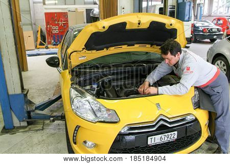 Portrait Of An Auto Mechanic At Work On A Car