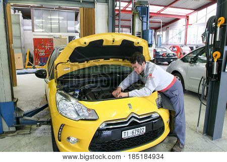 Portrait Of An Auto Mechanic At Work On A Car