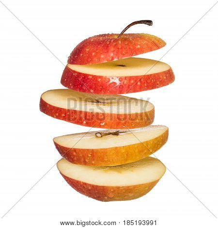 Flying apple. Sliced red apple isolated on white background. Levity fruit floating in the air.