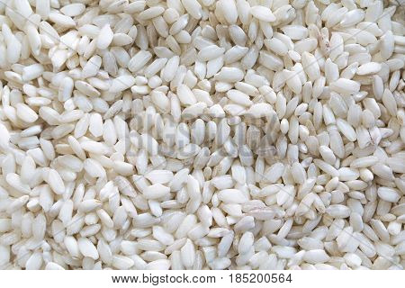 Arborio risotto rice raw close up from an overhead perspective