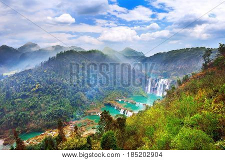 Jiulong Waterfall At Sunset In Luoping, China.