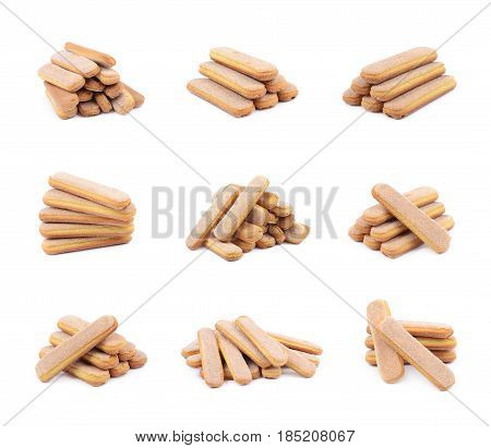 Pile of multiple ladyfinger savoiardi biscuit cookies, composition isolated over the white background, set of six different foreshortenings