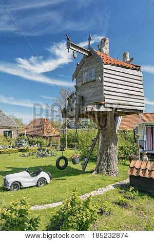 Treehouse in a garden in the village De Woude in The Netherlands