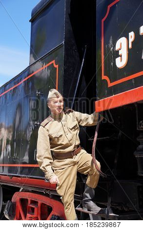 Fighter of Red Army in the form of times of World War II on a footboard of the old engine