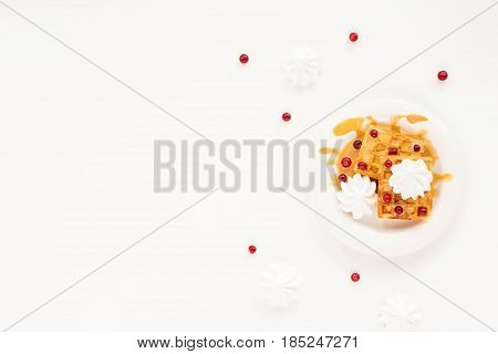 Plate Of Belgian Waffles With Caramel, Meringue And Berry On White Background. Flat Lay, Top View