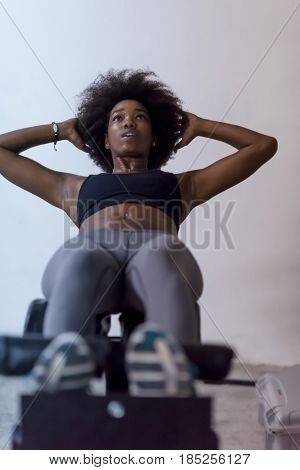 young fit african american woman doing sit ups in fitness studio at the gym.Abdominal exercises Sit up