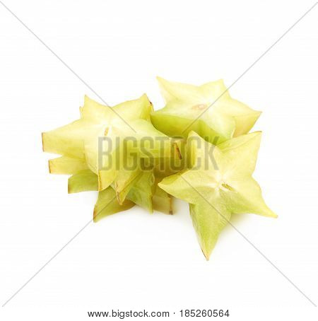 Pile of sliced carambola starfruit fruits isolated over the white background