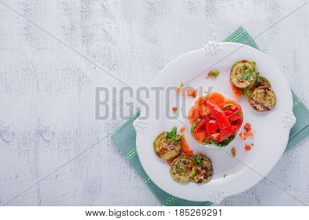 Rice timbale with fried zucchini, peppers, carrots