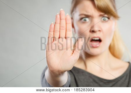 Female Shows Stop Sign By Her Hand.