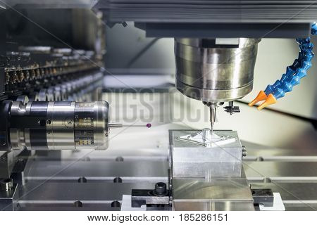 The CNC machine cutting work piece and the measurement probe in magazine.The hi-quality machining process concept.