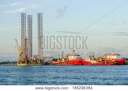 Labuan,Malaysia-June 17,2016:Multi function offshore support/platform supply vessels & Jackup oil rig platform under repair at shipyard in Labuan,Malaysia on 17th June 2016.