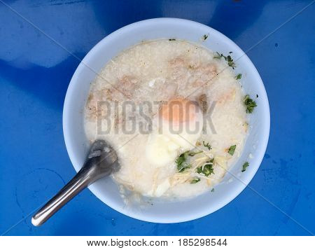 Traditional Thai Porridge Rice Gruel In White Bowl, Congee. In The Street Night Market.