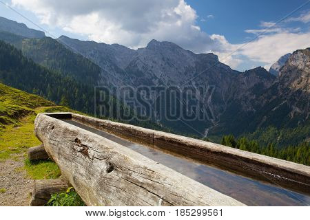 Rural scenery with wooden water well.Achensee Lake area Austria Tirol.
