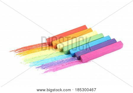 Rainbow gradient made of pastel crayon chalks over the colorful traces isolated over the white background