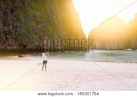 Maya Bay a tranquil beautiful beach surrounded by large limestone rock in Phi Phi Island Thailand with orange light filter