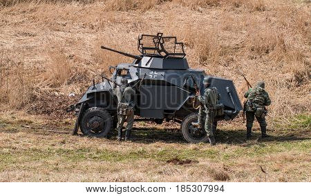 Gatchina Russia - May 7 2017: Historical reconstruction of the battles of World War II. Attack of the German soldiers. In combat an armored personnel carrier is used.
