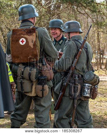 Gatchina, Russia - May 7, 2017: Historical reconstruction of the battles of World War II. German soldiers in full combat ammunition.