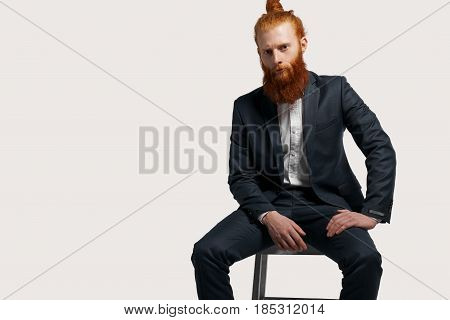 Serious ecological goods businessman hire new managers for a sale his product. Job interview concept to find new studetns after collage. Isolated cropped unformal office worker in black suite on chair