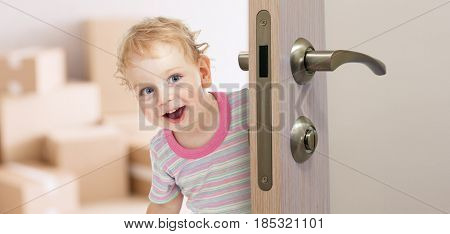 happy kid behind door in new room