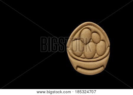 Dog biscuit on black background to connote a concept of feeding animals