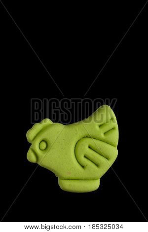 Dog biscuit on black background to connote a concept of feeding animals