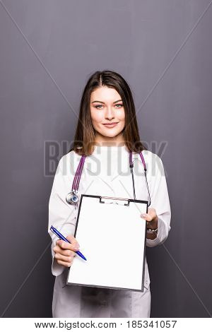 Smiling Doctor Woman With Documents And Pen For Your Signature Isolated On Grey