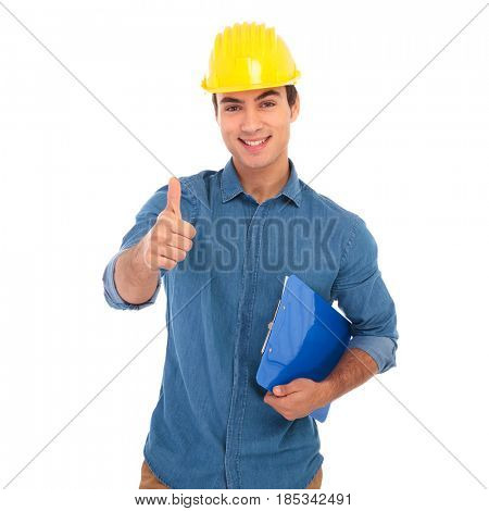 smiling young construcion engineer making the ok thumbs up hand sign on white background
