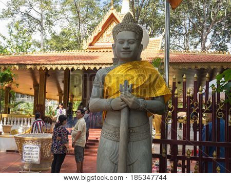 Siem Reap Cambodia - October 29 2016: Stone guard at the front gate of Preah Ang Chek and Preach Ang Chom Buddhist Shrine Siem Reap Cambodia