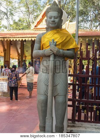 Siem Reap Cambodia - October 29 2016: Stone guard at the front gate of Preah Ang Chek and Preach Ang Chom Buddhist Shrine Siem Reap Cambodia