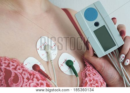 Electrodes Holter monitoring on the chest of a woman
