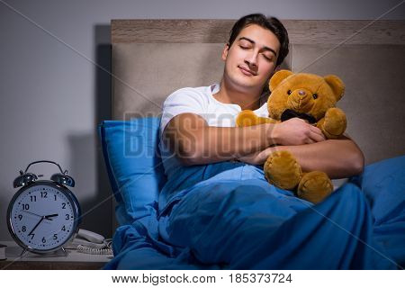 Young man sleeping in the bed