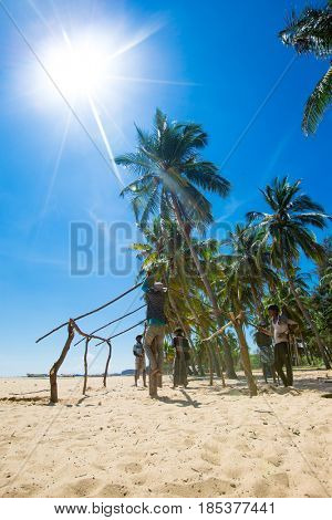 SRI LANKA - Mach 23: Local fishermen pull a fishing net from Indian Ocean on Mach 23, 2017 in Kosgoda, Sri Lanka. Fishing in Sri Lanka is the way they earn their living.