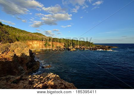 Beach by the cliff on the coast of the Caribbean sea on Cuba