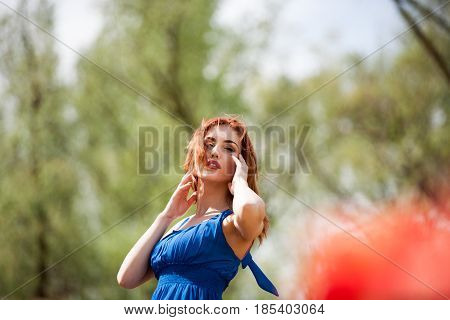 Dreammy woman in outdoor photo in sunny summer day. Beautiful girl in springtime