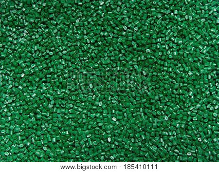 The Plastic Granules. Polymeric Dye Green For The Background . Dye For Plastics In Granules .
