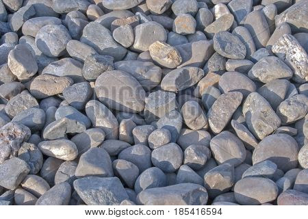 Pebble stones for background. Abstract background and texture with white pebbles. Stones texture and background. Garden decoration. Abstract texture and background for designers. Macro view of white pebbles