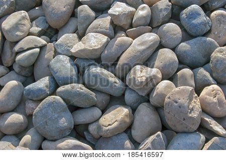 Pebble stones for background. Abstract background and texture with white pebbles. Stones texture and background. Garden decoration. Abstract texture and background for designers. Macro view of white pebbles