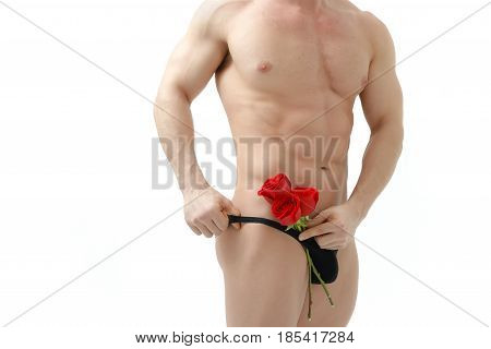 Handsome man holding a red rose and a bouquet of red roses. Sexy man gives a rose on a white background with a beautiful light. Isolated on white background